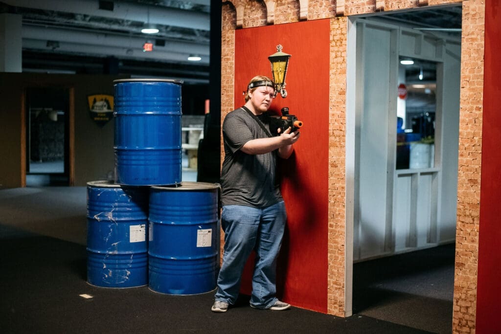 "Action-packed laser tag game with players wearing vests and holding laser guns in a futuristic arena."