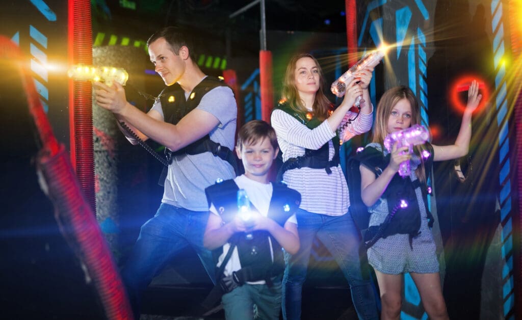 Excited,Kids,And,Theirs,Parents,In,Bright,Beams,Of,Laser