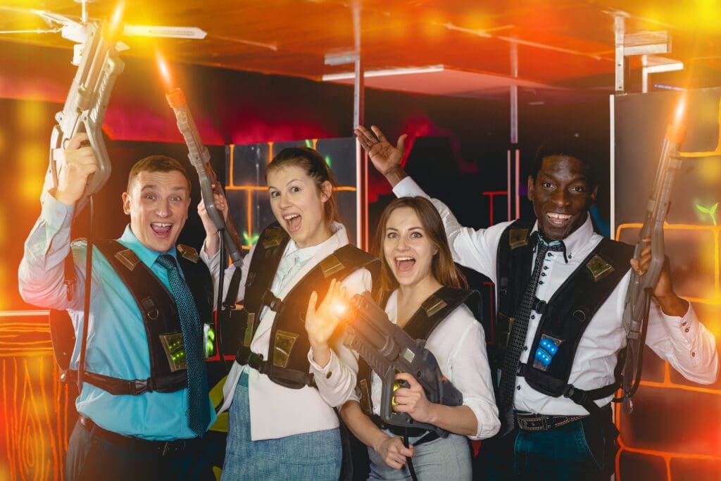 Group,Of,Jolly,Co-workers,Holding,Laser,Guns,And,Posing,At