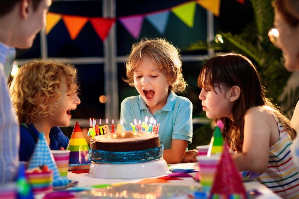 Kids,Birthday,Party.,Child,Blowing,Candles,On,Cake,And,Opening